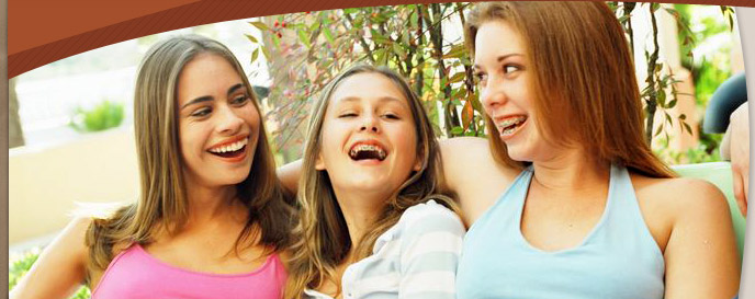 group of teen girls smiling and wearing braces