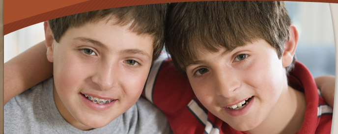 young boys smiling and wearing braces